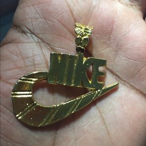 Gold NIKE pendant.